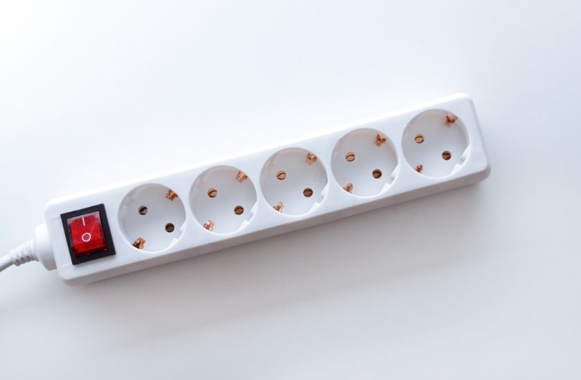 Power strip with multiple sockets and an illuminated power switch, designed for home and office use to extend connectivity for electrical devices.